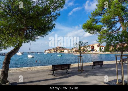 Belle vue sur la ville ensoleillée de Rovinj avec la mer adriatique et les bateaux depuis le trottoir Banque D'Images