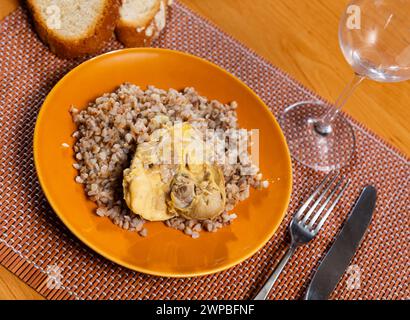 Sarrasin bouilli dans un bol avec cuisses de poulet. Table de dîner, concept de nourriture saine Banque D'Images