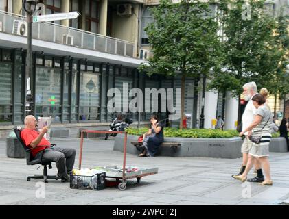 Un vendeur serbe de fruits lisant le journal dans le centre-ville de Belgrade, en Serbie. Banque D'Images