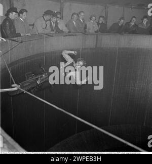 Mur de la mort 1952. Le mur de la mort, le motordrome, le vélodrome ou le puits de la mort est un défilé latéral de carnaval comportant un cylindre en bois en forme de silo ou de tonneau, dont le diamètre varie généralement de 6,1 à 11,0 m (20 à 36 pieds) et fait de planches de bois, à l'intérieur desquelles les motocyclistes se déplacent le long du mur vertical et effectuent des cascades. maintenu en place par friction et force centrifuge. Le mur original de la mort était en 1911 sur l'île Coney aux États-Unis. Photographié un motocycliste à grande vitesse dans le vélodrome, montrant, avec ses mains en l'air, pas sur le guidon comme il le devrait. Photo Eva Lööw. Banque D'Images