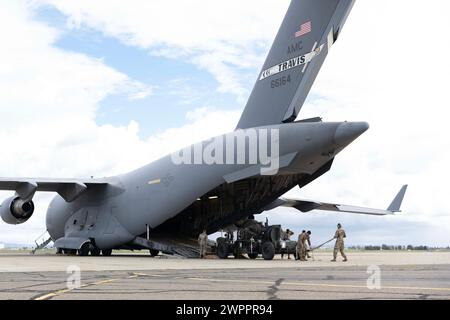 Des aviateurs américains affectés à la base aérienne de Travis, en Californie, déchargent un système d'arrêt d'avion mobile d'un C-17 Globemaster III à l'aéroport de Mather, en Californie, le 3 mars 2024. Des aviateurs affectés au 21e escadron de transport aérien ont transporté le MAAS, un système de freinage d’avion, à Mather pour être utilisé en cas d’urgence lors du salon aéronautique 2024 Wings Over Solano de Travis AFB et de la journée portes ouvertes. (Photo de l'US Air Force par l'aviateur principal Alexander Merchak) Banque D'Images