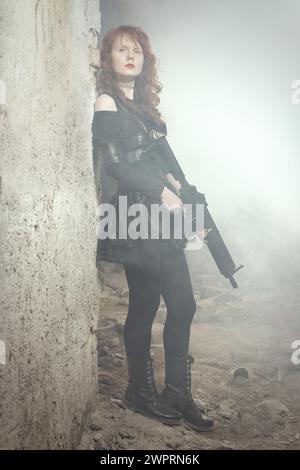 Femme combattante observant et regardant autour dans les ruines du bâtiment Banque D'Images