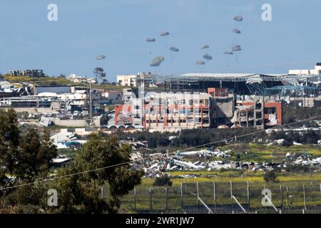 Sud d'Israël, Israël. 10 mars 2024. Ce que l'on pense être un C-130 de l'armée de l'air américaine lâche de l'aide humanitaire en parachute au-dessus du nord de la bande de Gaza vu de l'intérieur du sud d'Israël le 10 mars 2024. Les États-Unis et d'autres pays continuent de distribuer de la nourriture et d'autres fournitures d'aide humanitaire aux Palestiniens dans le besoin dans la bande de Gaza juste avant le début du mois sacré islamique du Ramadan alors que la guerre d'Israël contre le Hamas se poursuit. Photo de Jim Hollander/UPI crédit : UPI/Alamy Live News Banque D'Images