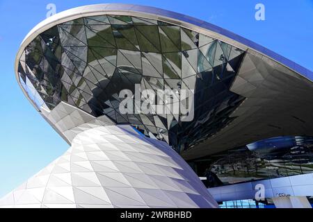 Un bâtiment moderne avec une façade en verre réfléchissant sous un ciel bleu clair, BMW WELT, Munich, Allemagne Banque D'Images