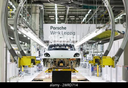 Leipzig, Allemagne. 11 mars 2024. Une Porsche Macan traverse la chaîne de montage de l'usine de Leipzig. Le constructeur de véhicules sportifs et tout-terrain Porsche publie mardi 12 mars ses chiffres d'affaires de l'année écoulée à l'usine Porsche de Leipzig. Crédit : Jan Woitas/dpa/Alamy Live News Banque D'Images