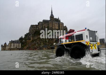 © PHOTOPQR/Ouest FRANCE/Martin ROCHE/Ouest-FRANCE ; Mont Saint Michel ; 12/03/2024 ; ce mardi 12 mars 2024 reportage au Mont - Saint - Michel/Mont-Saint-Michel ( Manche/Normandie ) qui est devenu une île grâce aux grandes marées ( le coefficient de marée est à 117 dans la baie du Mont Saint-Michel aujourd'hui ) ici les pompiers traversent l'eau devant le Mont Saint Michel ?photographe: Martin ROCHE 03/12/2024 le Mont-Saint-Michel (Manche/Normandie), qui est redevenu une île grâce aux marées hautes (la marée est de 117 dans la baie du Mont Saint-Michel aujourd'hui). Banque D'Images
