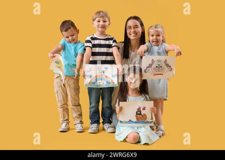 Petits enfants avec des dessins sur fond jaune Banque D'Images