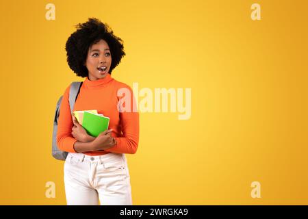 Jeune étudiant afro-américain surpris et excité avec un sac à dos Banque D'Images