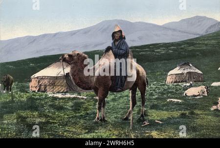 Kazakh sur un chameau avec Yourts en arrière-plan, vallée de l'Arakan, affluent de la rivière Chernaia Berel, 1911-1913. D'une collection de cartes postales en couleur de l'Altaï, ou Altaï, région des montagnes du sud de la Sibérie au début du XXe siècle. En 1907, Borisov commence son expédition dans les montagnes de l'Altaï, qui dure jusqu'en 1911. Il a pris environ 1 500 photographies au cours de cette expédition, qu'il a présentées au public à son retour à Barnaoul à l'aide d'une lanterne magique. Les photographies représentent des vues de la nature dans les coins reculés des montagnes de l'Altaï et de l'Altaï et du Kazakh Banque D'Images