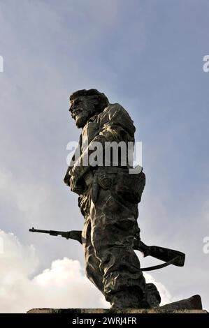 Monument à un guerrier réfléchi (Memorial del Ernesto Che Guevara Monument de 6 mètres de haut statue en bronze), Santa Clara, avec fusil devant un nuageux Banque D'Images