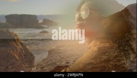 Image d'une femme afro-américaine dans des lunettes de soleil sur un paysage ensoleillé Banque D'Images