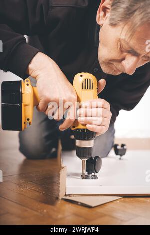 Homme déballage et montage de l'ensemble de trois tiroirs Banque D'Images