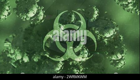 Image du signe de danger biologique et des cellules covid 19 flottant sur fond vert Banque D'Images