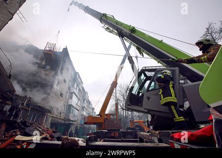 Non exclusif : SUMY, UKRAINE - 13 MARS 2023 - les sauveteurs utilisent de l'équipement de haute altitude et des outils spéciaux pour rechercher des personnes sous les décombres d'un f Banque D'Images