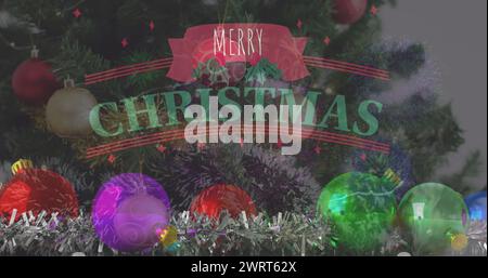 Image du texte de voeux de noël sur l'arbre de noël et les décorations Banque D'Images