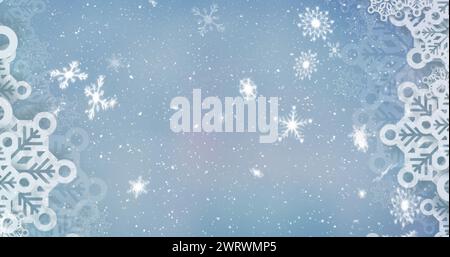 Image de flocons de neige tombant sur fond bleu Banque D'Images