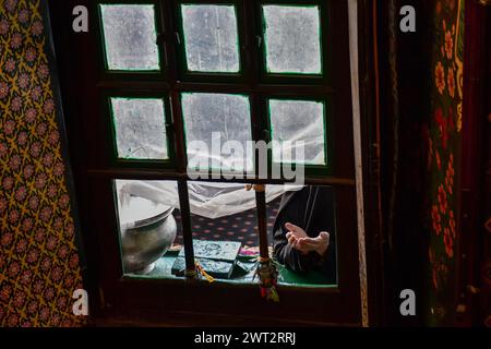 Srinagar, Inde. 15 mars 2024. Une musulmane cachemire prie au sanctuaire de Khwaja Naqshband Sahib pendant le premier vendredi du Ramadan à Srinagar. Les musulmans à travers le monde marquent le mois du Ramadan, le mois le plus Saint du calendrier islamique au cours duquel les dévots jeûnent de l'aube au crépuscule. Crédit : SOPA images Limited/Alamy Live News Banque D'Images