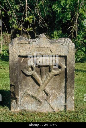 Église St Andrew, Hartburn, Morpeth, Northumberland. Pierre tombale de Thomas Chicken 1723. Outils du commerce - pelle, bêche, et marteau. Banque D'Images