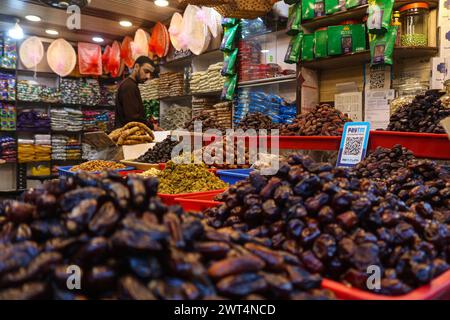 Srinagar, Inde. 15 mars 2024. 15 mars 2024, Srinagar, Inde : Un vendeur cachemiri vend des dates le premier vendredi du Ramadan à Srinagar. Les musulmans du monde entier marquent le mois sacré du Ramadan, lorsque les fidèles jeûnent de l'aube au crépuscule. Le 15 mars 2024, Srinagar, Inde. (Photo de Firdous Nazir/ crédit : Eyepix Group/Alamy Live News Banque D'Images