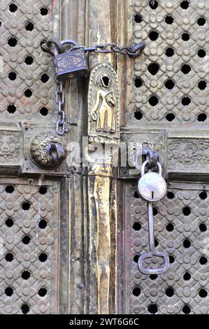 Porte en bois à l'ancienne détaillée avec des garnitures en métal élaborées et des cadenas, vallée de Katmandou. Katmandou, Népal Banque D'Images