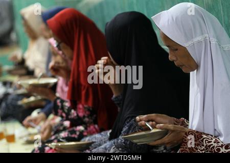 17 mars 2024, Bantul, Yogyakarta, Indonésie : les musulmans indonésiens mangent de la bouillie de légumes comme repas pour rompre le jeûne pendant le mois Saint du Ramadan connu sous le nom de ''Takjil'' à la mosquée Sabilurrosyad ou mosquée Kauman. La mosquée maintient toujours la tradition de takjil sous la forme de bouillie de légumes. La nourriture avec une texture lisse et douce est faite par les gens qui travaillent ensemble. Un jour ordinaire, l'administrateur de la mosquée peut servir 100 portions de bouillie de légumes. Mais le vendredi, le porridge de légumes servi peut atteindre 400 portions. (Crédit image : © Angga Budhiyanto/ZUMA Press Wire) EDITO Banque D'Images