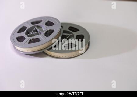 Deux bobines de film de 8 mm old School sur un fond blanc avec une ombre tombant à droite. Banque D'Images