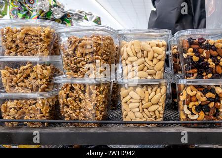 Noix décortiquées et amandes et noix mélangées dans des boîtes en plastique transparent exposées à la vente dans un supermarché Banque D'Images