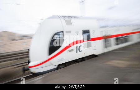 Hanovre, Allemagne. 18 mars 2024. Un train Intercity 2 passe par la gare centrale de Hanovre (prise de vue avec une vitesse d'obturation lente). Les deux parties au conflit salarial à Deutsche Bahn ont repris les négociations. Selon un communiqué de Deutsche Bahn, la compagnie et le syndicat des conducteurs de train GDL sont confiants de parvenir à un accord cette semaine. Crédit : Julian Stratenschulte/dpa/Alamy Live News Banque D'Images