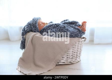 Mignon bébé nouveau-né de dormir dans le panier à la maison Banque D'Images