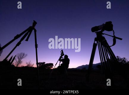 Astronome avec un appareil photo photographiant le ciel nocturne. Banque D'Images