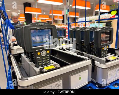 Francfort, Allemagne - 28 décembre 2023 : appareils électroniques portables pour le contrôle des stocks ancrés dans un environnement de vente au détail. Banque D'Images