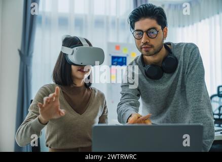 Codage de programme de développement asiatique et indien envoyé au casque de réalité virtuelle pour mettre en œuvre le projet ai au bureau Banque D'Images