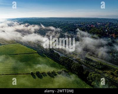 Une matinée sereine avec de la brume s'élevant doucement au-dessus d'un paysage luxuriant Banque D'Images