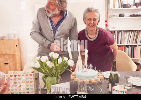 Couple joyeux célébrant avec un gâteau d'anniversaire. Banque D'Images
