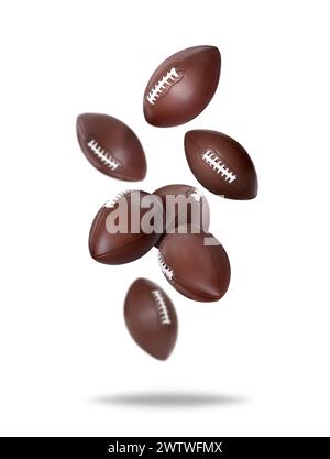Balles de football américain tombant sur fond blanc Banque D'Images