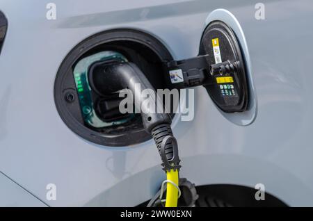 Voiture électrique, ricarica, câble et porte d'alimentation. la transition énergétique accroît les incitations pour les voitures électriques, afin de réduire la consommation d’huile. Banque D'Images