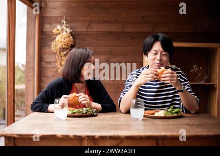 Deux personnes mangeant un sandwich Banque D'Images