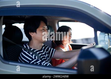 Un homme et une femme conduisant une voiture Banque D'Images