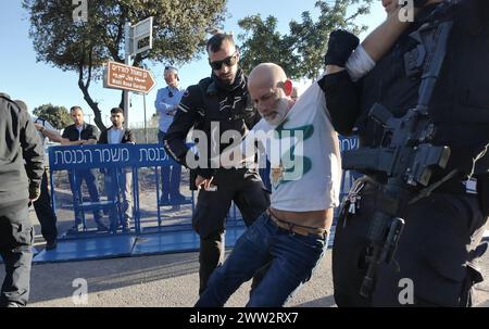 Des membres des forces de sécurité israéliennes arrêtent un manifestant alors que des manifestants anti-gouvernementaux bloquent l’entrée de la Knesset, s’enchaînant lors d’une manifestation contre le premier ministre israélien Benjamin Netanyahu et son gouvernement, appelant à la démission de Netanyahu et à des élections anticipées le 20 mars 2024 à Jérusalem, en Israël Banque D'Images