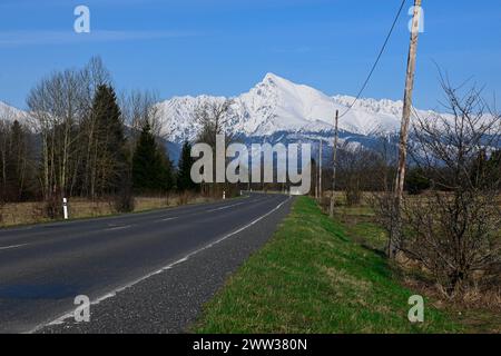 Route avec vue sur les montagnes enneigées (Hautes Tatras - Krivan). Banque D'Images