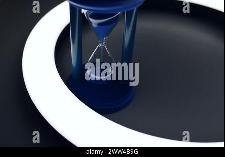 Sable tombant dans le sablier bleu à l'intérieur D'Un anneau de lumière isolé photo stock Banque D'Images