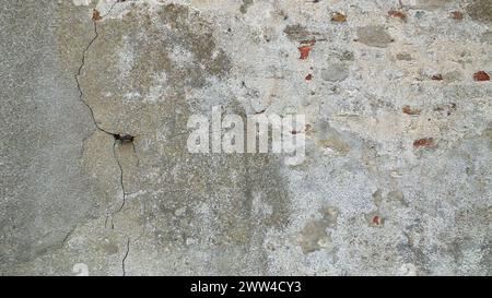 Weathered Old Wall with Cracks and Exposed Bricks - Abstract Background Texture, Germany, Moenchengladbach Stock Photo