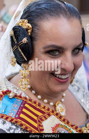 La tenue d’une Fallera, tissée de tradition et de teintes vibrantes, raconte une histoire de célébration. Ses bijoux dorés et sa robe brodée reflètent le festival » Banque D'Images