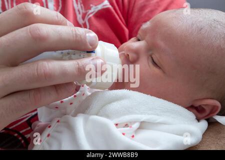 Père donnant le biberon à son enfant à la maternité. Banque D'Images