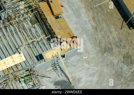 Constructeurs travaillant sur la construction de toit de maison résidentielle inachevée avec structure de cadre en bois dans la région suburbaine de Floride. Développement du logement Banque D'Images