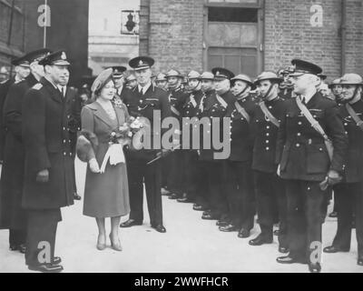 Une photographie datant d'environ 1940 montre le roi George VI et la reine Elizabeth inspectant la police métropolitaine pendant la seconde Guerre mondiale. Probablement là pour offrir leur soutien, cette image met en évidence les efforts du couple royal pour renforcer le moral et montrer sa solidarité avec ceux qui servent sur le front intérieur pendant cette période sombre. Banque D'Images