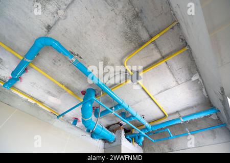 Le système de conduite d'eau, les conduites d'eaux usées et le câblage électrique sont soigneusement installés sous le plafond. Banque D'Images