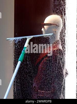 New York, États-Unis. 25 mars 2024. Un travailleur nettoie les fenêtres du magasin Gucci Fifth Avenue à New York le lundi 25 mars 2024. Photo de John Angelillo/UPI crédit : UPI/Alamy Live News Banque D'Images