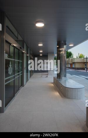 Entrée d'un bâtiment commercial, plus précisément d'un hôpital. Prise de vue longue exposition avec flou de mouvement d'un homme montant les escaliers Banque D'Images