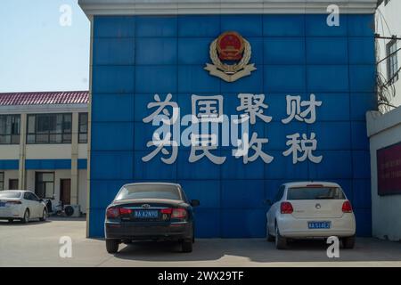 Un bureau local des impôts dans la ville de Jingxing, Hebei, Chine. Les caractères chinois se lisent comme suit : rassemblez la richesse pour le pays et collectez les impôts pour le peuple. Banque D'Images